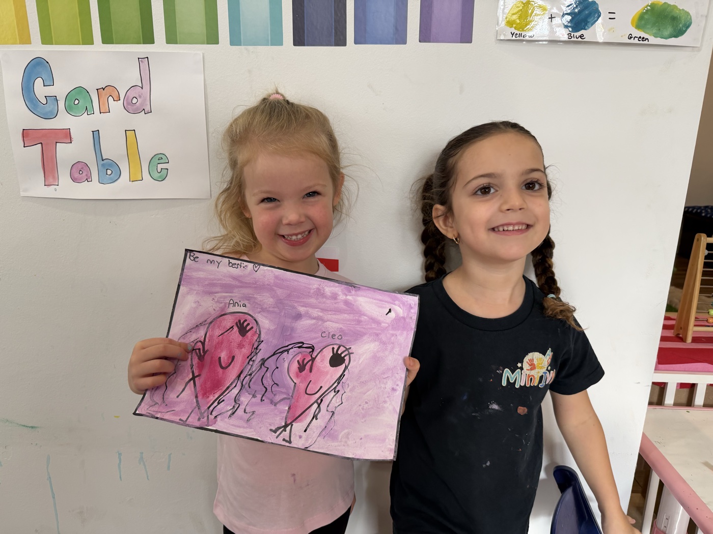 Two friends holding their bestie hearts painting at Mini Ivy art studio