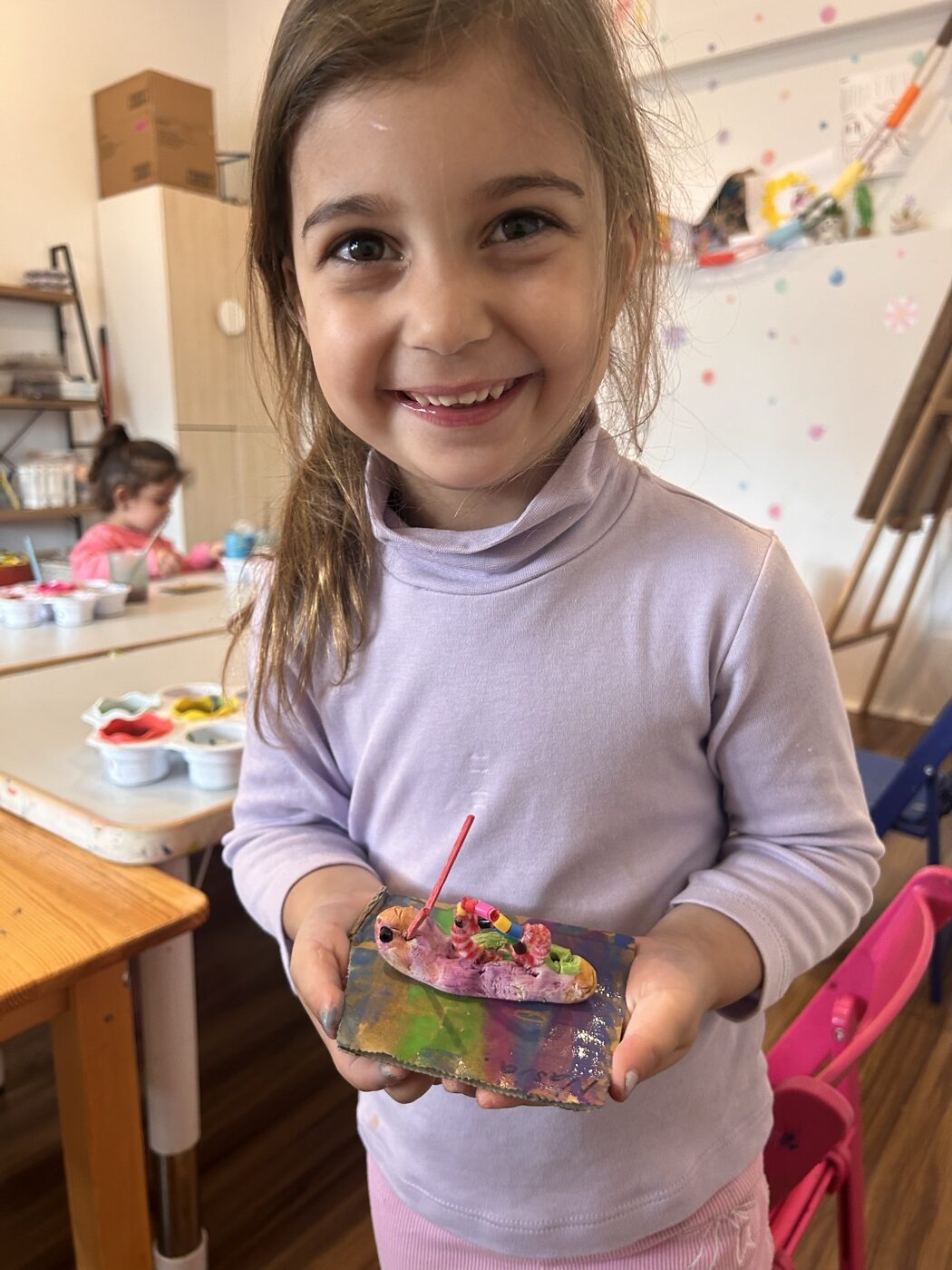 Child with their clay creation at Mini Ivy, minutes from Hindmarsh
