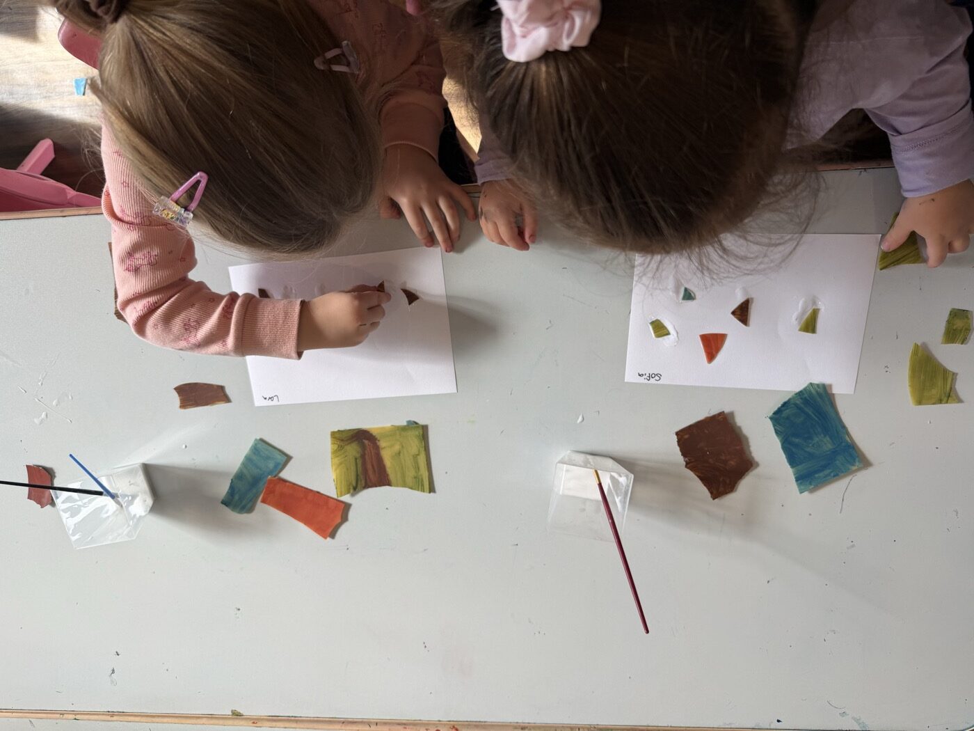 Children working on mosaic collages at Mini Ivy near Henley Beach