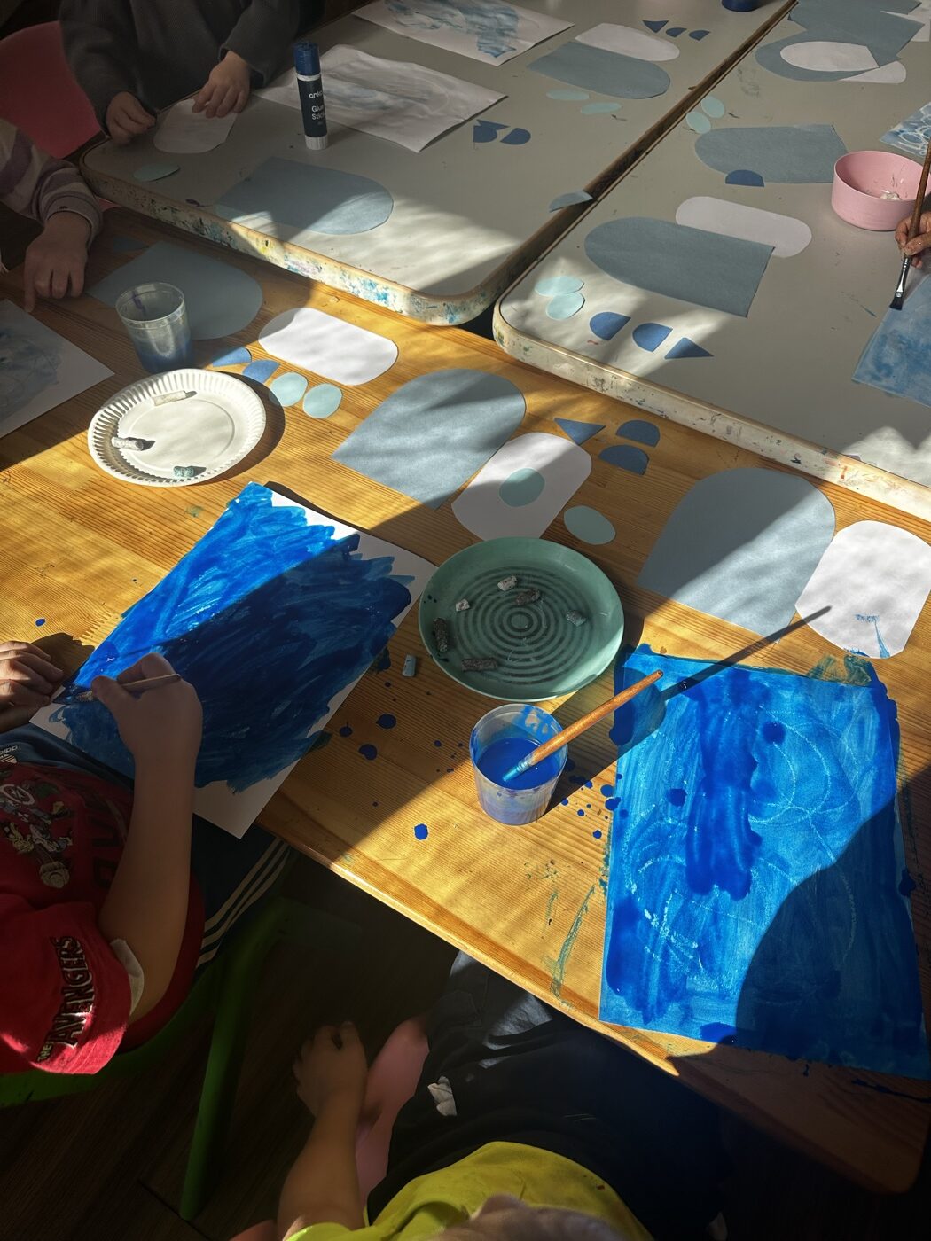 Children painting together at a Mini Ivy art session in Torrensville