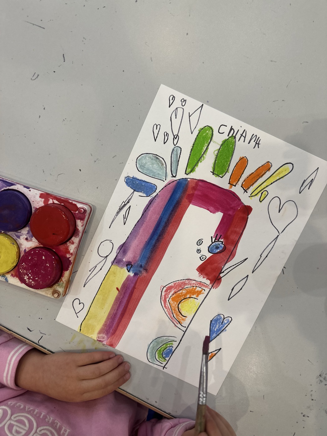 A rainbow painting made by a child at Mini Ivy