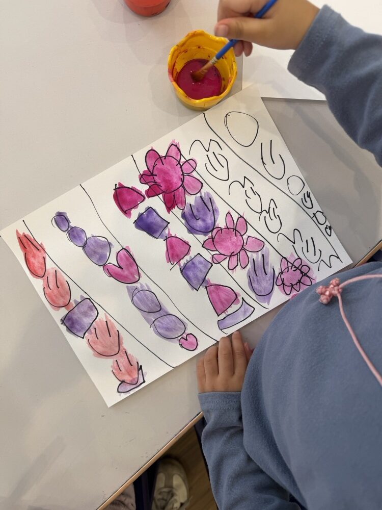 Rows of pink and purple painted shapes with marker outlines