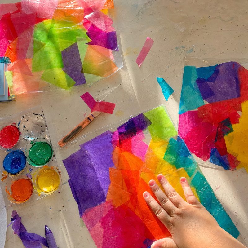 Bright tissue paper suncatchers glowing in a window